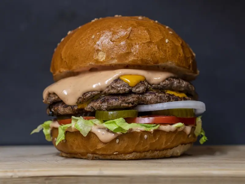Juicy gourmet burger with bacon and melted cheese on brioche bun