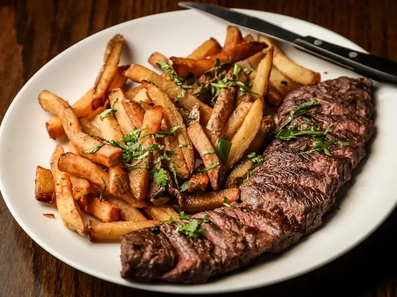 Perfectly grilled ribeye steak with grill marks and sides